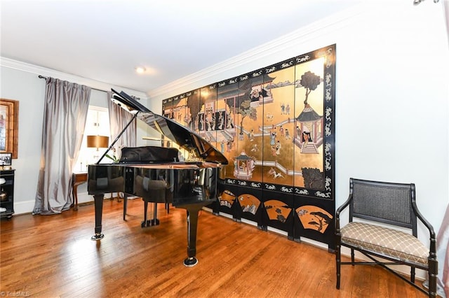 living area featuring wood finished floors, baseboards, and ornamental molding