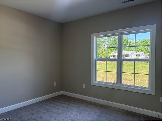 864 Midway School Rd, Winston-Salem, NC 27107 - spare room with dark colored carpet, baseboards, visible vents, and a healthy amount of sunlight
