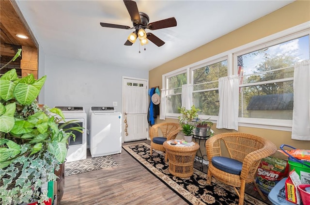 sitting room with ceiling fan, washer and clothes dryer, and dark hardwood / wood-style floors