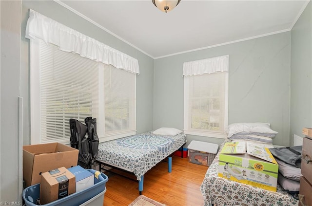 bedroom featuring crown molding and hardwood / wood-style flooring