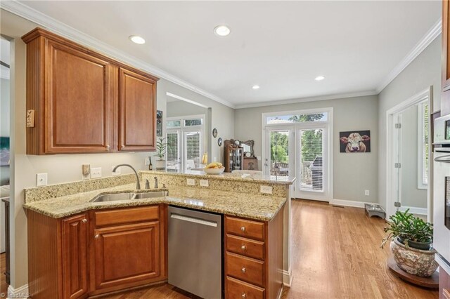 3741 Canter Dr, Trinity, NC 27370 - kitchen with dishwasher, light stone counters, light wood-style flooring, a peninsula, and brown cabinetry