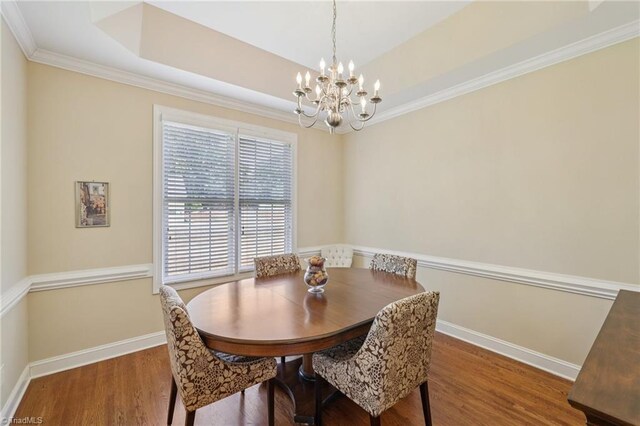 3741 Canter Dr, Trinity, NC 27370 - dining space with a chandelier, wood finished floors, a tray ceiling, and crown molding