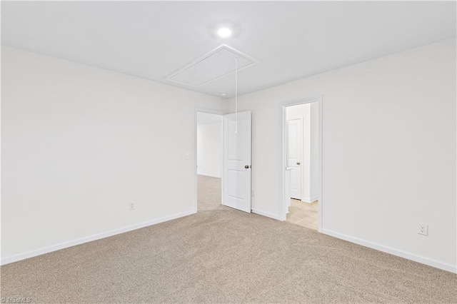 carpeted empty room featuring recessed lighting, attic access, and baseboards