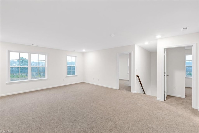 carpeted spare room with recessed lighting, visible vents, and baseboards