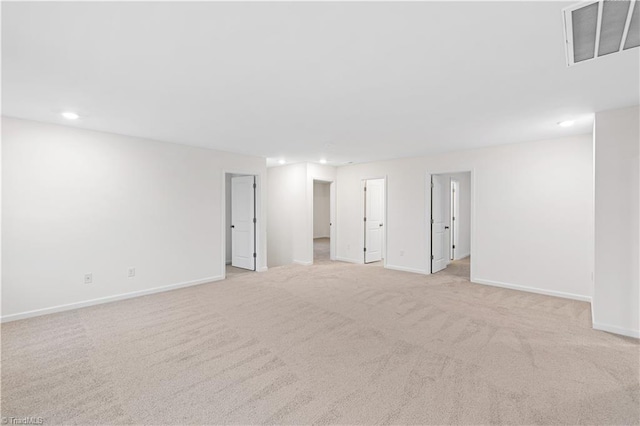 interior space featuring light carpet, visible vents, and baseboards