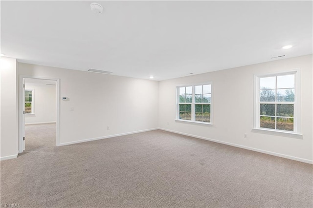 spare room with visible vents, recessed lighting, baseboards, and carpet floors