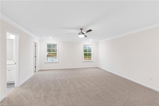 empty room featuring baseboards, ceiling fan, and ornamental molding