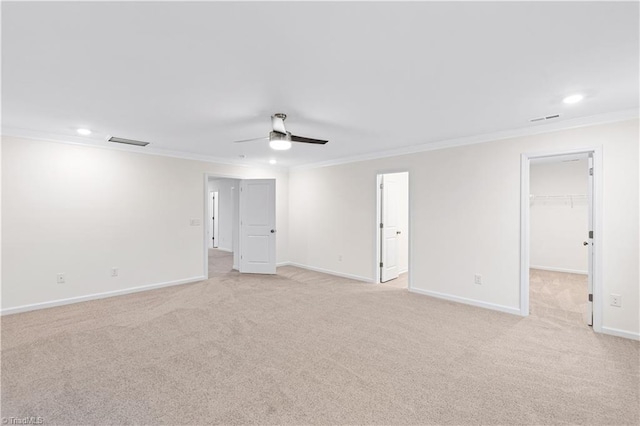 unfurnished room featuring visible vents, baseboards, light colored carpet, ornamental molding, and a ceiling fan