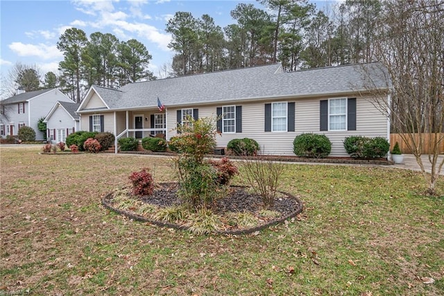 ranch-style home with covered porch and a front lawn