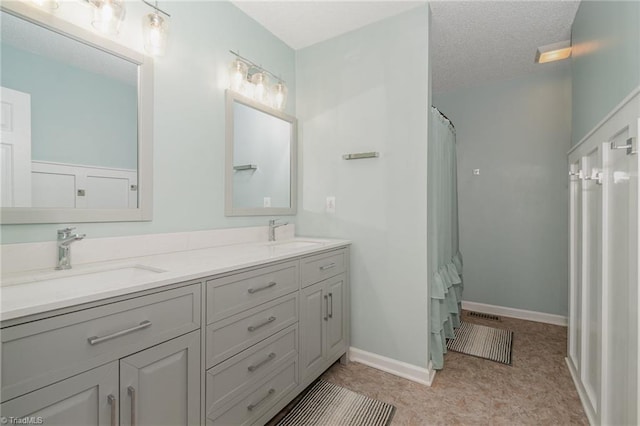 bathroom featuring a shower with curtain, vanity, and a textured ceiling