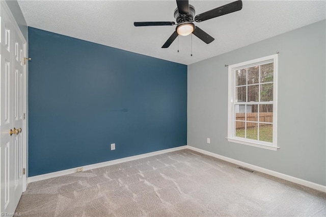 carpeted empty room featuring ceiling fan