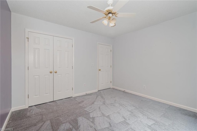 unfurnished bedroom with light carpet, a closet, and ceiling fan