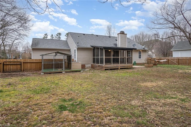 rear view of house featuring a gazebo, a sunroom, and a lawn