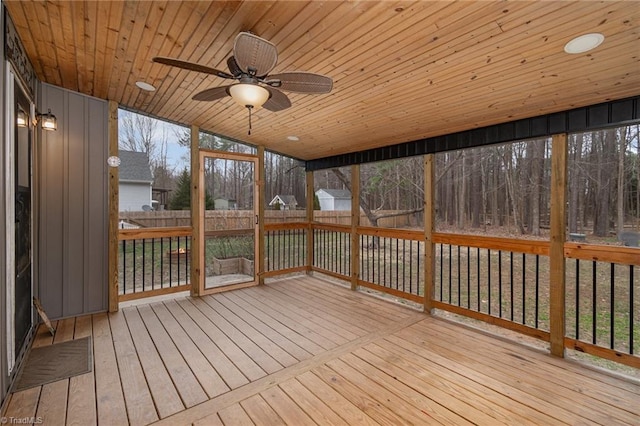 unfurnished sunroom with wood ceiling and ceiling fan