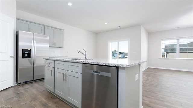280 Lisa Ln, Winston-Salem, NC 27107 - kitchen featuring stainless steel appliances, a sink, gray cabinets, dark wood-style flooring, and light stone countertops