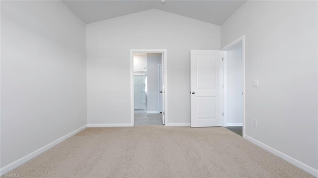 280 Lisa Ln, Winston-Salem, NC 27107 - unfurnished bedroom with carpet flooring, vaulted ceiling, baseboards, and ensuite bathroom