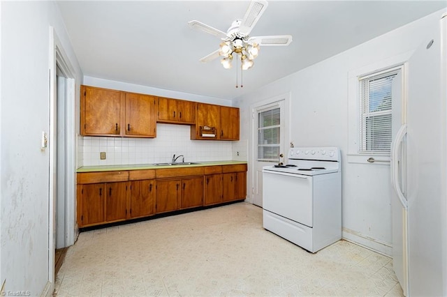 800 Essex Rd, Winston-Salem, NC 27105 - kitchen featuring white appliances, brown cabinets, a sink, and light countertops