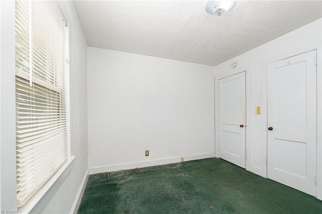 800 Essex Rd, Winston-Salem, NC 27105 - unfurnished bedroom with carpet floors, baseboards, and a textured ceiling