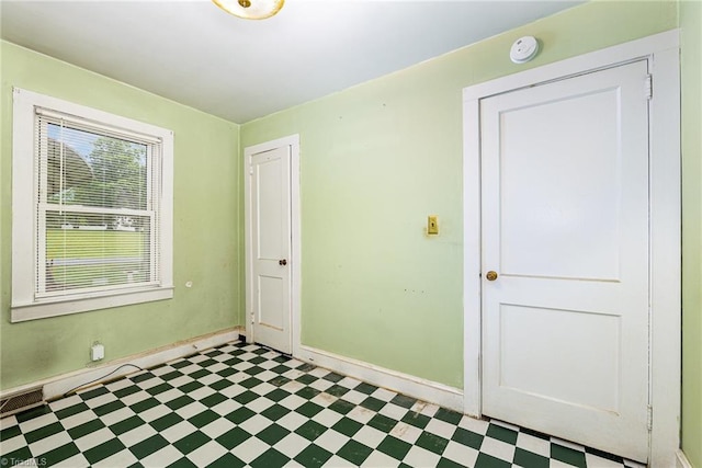 800 Essex Rd, Winston-Salem, NC 27105 - empty room with tile patterned floors, baseboards, and a smoke detector