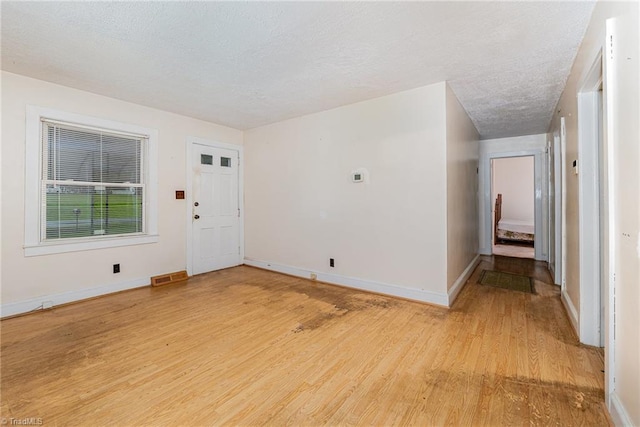 800 Essex Rd, Winston-Salem, NC 27105 - unfurnished room with light wood-type flooring, a textured ceiling, and baseboards