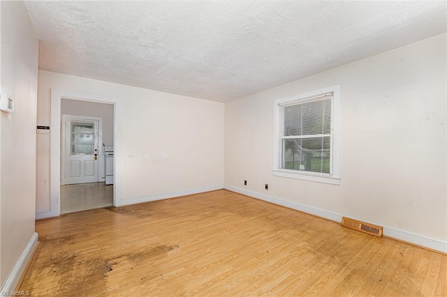 800 Essex Rd, Winston-Salem, NC 27105 - empty room with wood finished floors, baseboards, and a textured ceiling