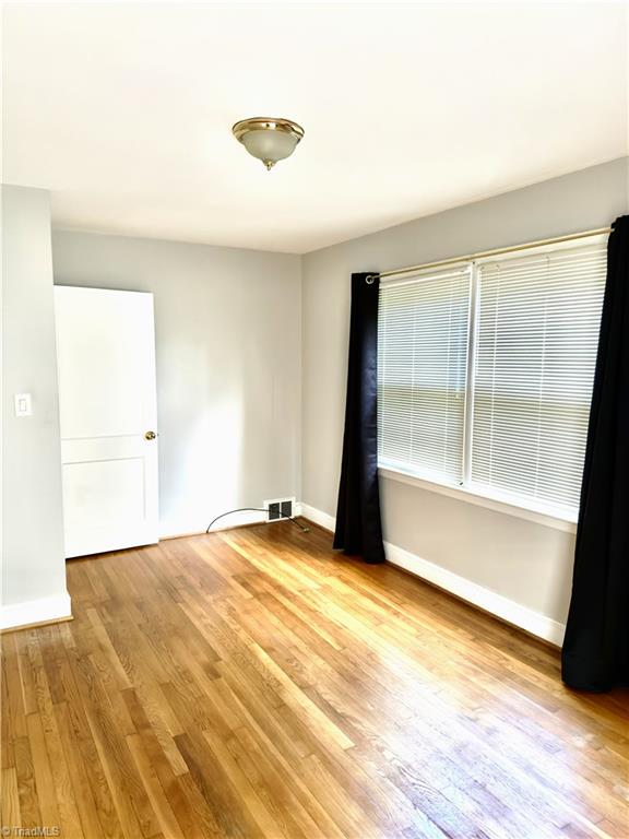 211 Hermitage Rd, Greensboro, NC 27403 - unfurnished room featuring light wood-style floors and baseboards