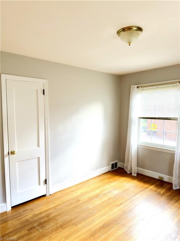 211 Hermitage Rd, Greensboro, NC 27403 - spare room featuring light wood-style flooring and baseboards