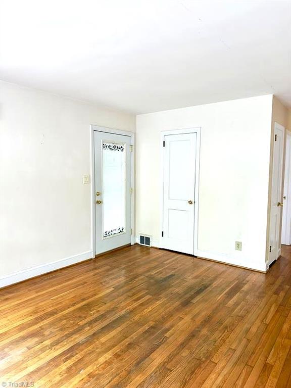 211 Hermitage Rd, Greensboro, NC 27403 - spare room featuring wood finished floors and baseboards