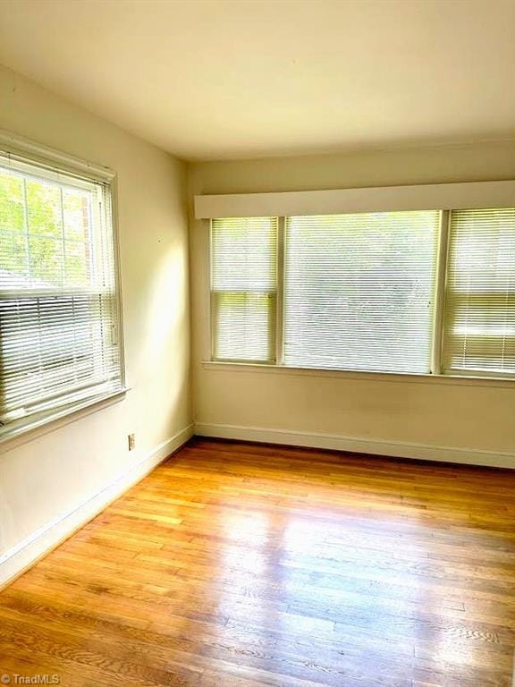 211 Hermitage Rd, Greensboro, NC 27403 - unfurnished room with healthy amount of natural light, wood finished floors, and baseboards