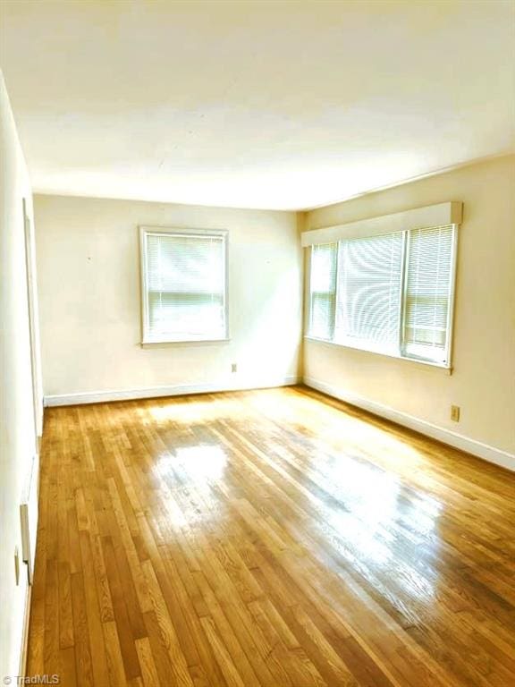 211 Hermitage Rd, Greensboro, NC 27403 - spare room with wood finished floors and baseboards