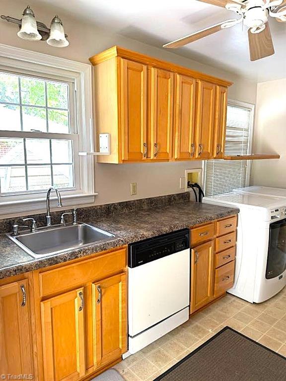 211 Hermitage Rd, Greensboro, NC 27403 - kitchen with dishwasher, washer / clothes dryer, a ceiling fan, a sink, and dark countertops