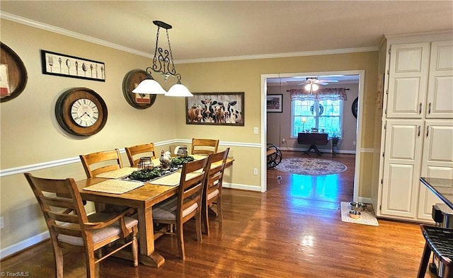 dining space featuring ornamental molding, a ceiling fan, baseboards, and wood finished floors