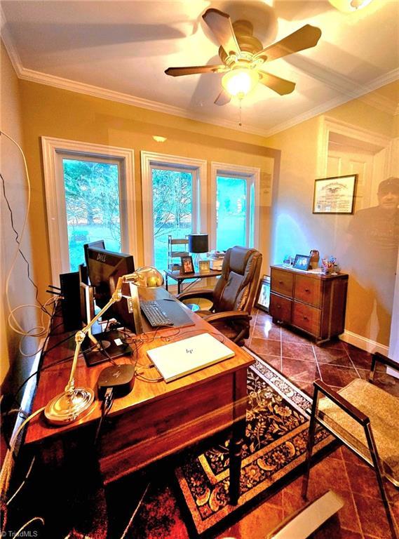 office area featuring ceiling fan, baseboards, and crown molding