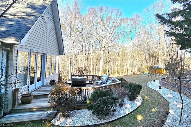 exterior space featuring a deck and a view of trees