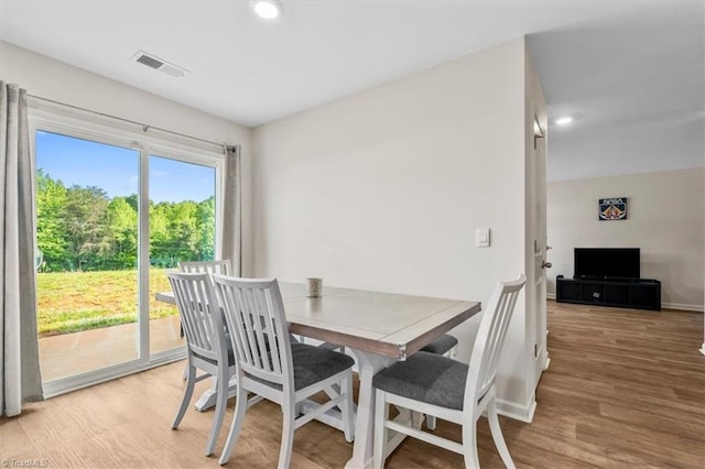 dining room with wood finished floors, baseboards, and recessed lighting