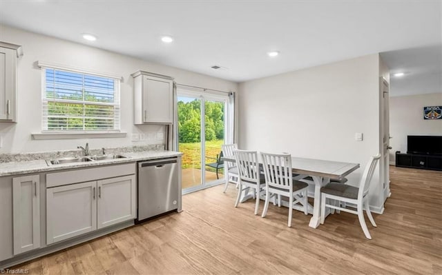 kitchen with dishwasher, a sink, light wood-style floors, recessed lighting, and gray cabinetry