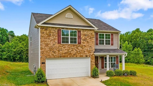 traditional-style home with a front lawn, a garage, brick siding, and concrete driveway