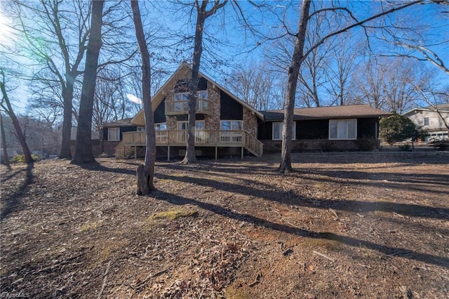 rear view of property with a wooden deck