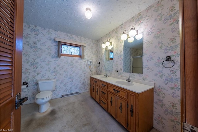 bathroom featuring a textured ceiling, an enclosed shower, vanity, and toilet