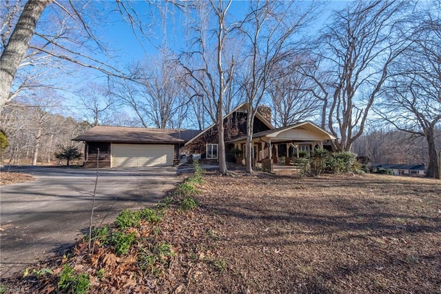 ranch-style house with covered porch and a garage