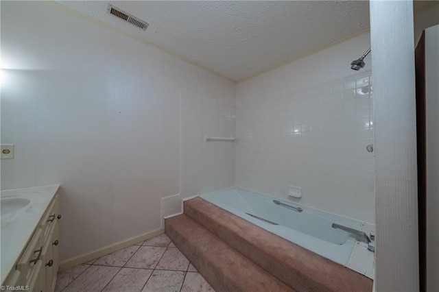 bathroom featuring shower / bathing tub combination, tile patterned flooring, a textured ceiling, and vanity