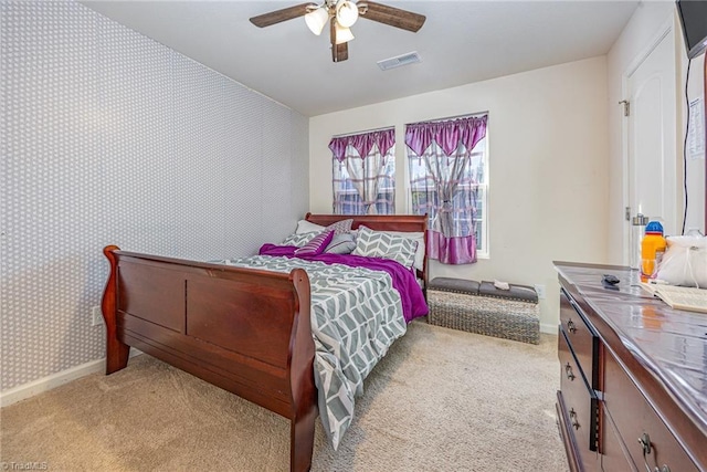 bedroom featuring light colored carpet, baseboards, wallpapered walls, and visible vents
