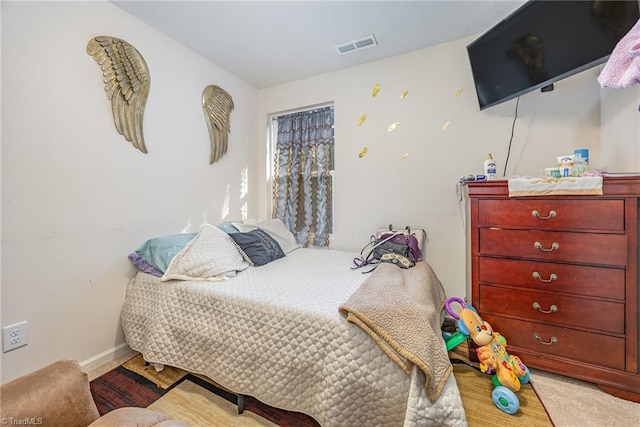 bedroom featuring baseboards, visible vents, and carpet floors