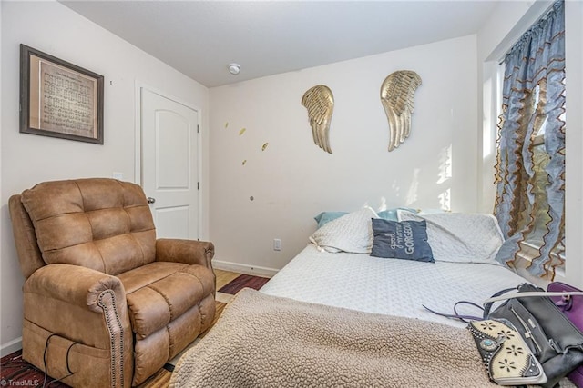 bedroom featuring baseboards and wood finished floors