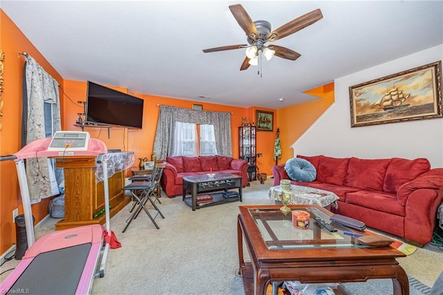 carpeted living room with a ceiling fan