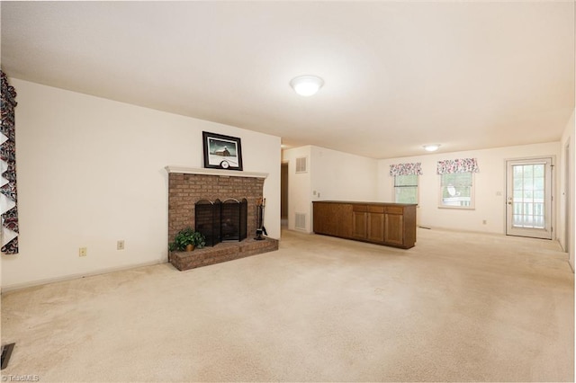 unfurnished living room with light colored carpet and a fireplace