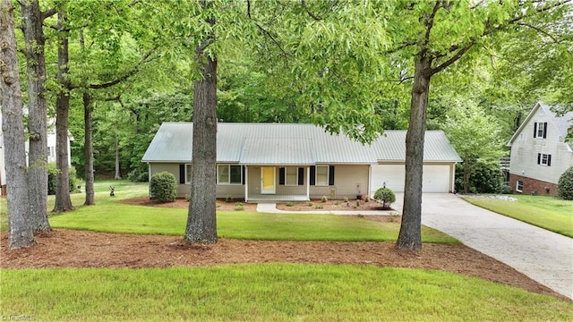 ranch-style home with a front yard, a porch, and a garage