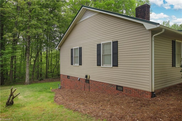 view of side of home with a lawn