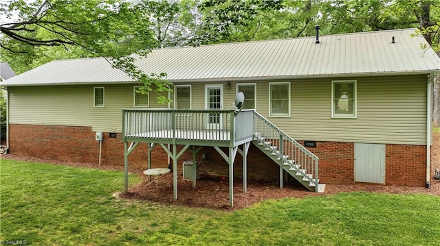 rear view of property with a yard and a deck