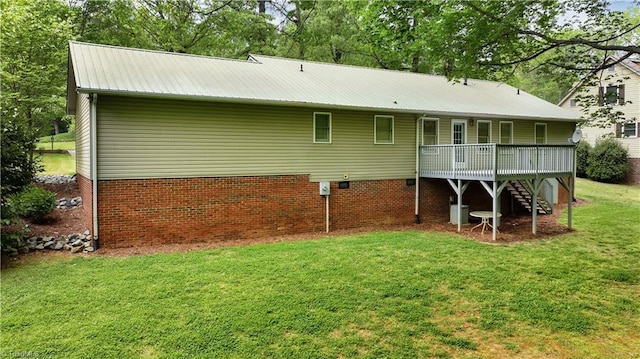 back of house featuring a yard and a wooden deck